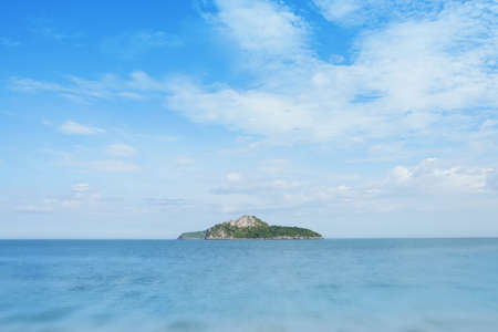The blur cool sea background on horizon tropical sandy beach; relaxing outdoors vacation with heavenly mind view at a resort deck touching sunshine, sky surf summer clouds and light blue wave ocean.の写真素材