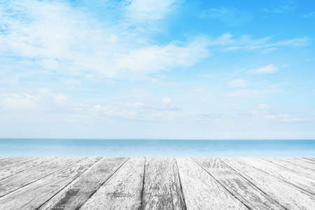 Wood tabletop foreground with sunshine clouds sky during morning background. Blue,white pastel...