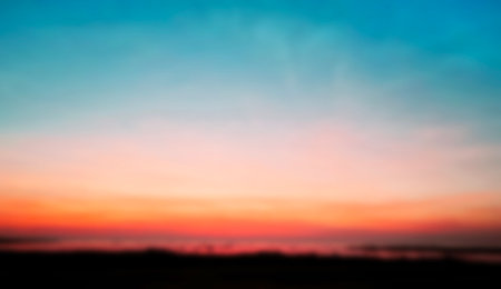 Blurred pastels gradient sunset background on soft nature sunrise peaceful morning river outdoor. heavenly mind view at a resort deck touching sunshine, sky summer clouds.の写真素材