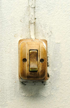 Old switch on white wallの写真素材