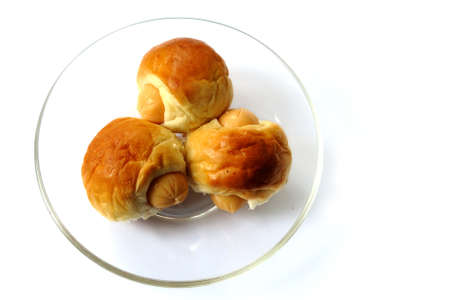 Three sausage sandwich  on glass disk isolatedの写真素材