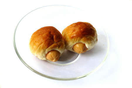 Two sausage sandwich  on glass disk isolatedの写真素材