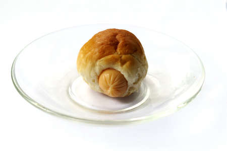 Single sausage sandwich  on glass disk isolatedの写真素材