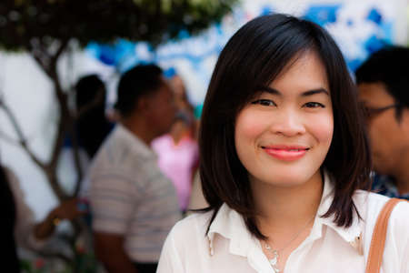 smiling girl in the crowdedの写真素材