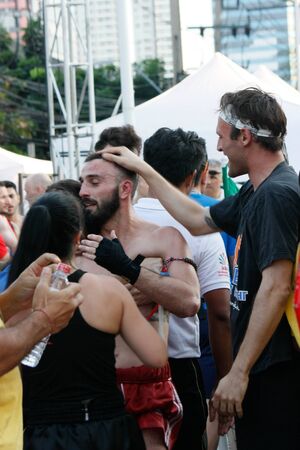 Muay Thai boxer hugs his friends with gratful and his proud to win the fightのeditorial素材