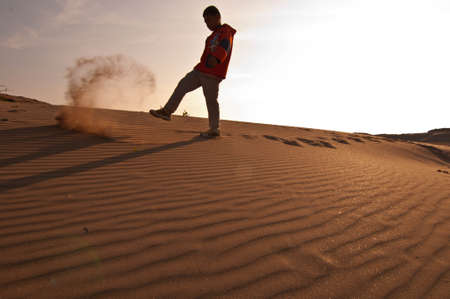 The angry boy kick the sandの写真素材