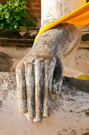 Hand of buddha and yellow clothesの写真素材