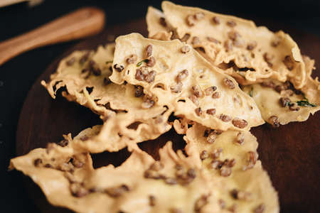 Crispy peanut crackers are an Indonesian food snack or called Peyek. Black Background