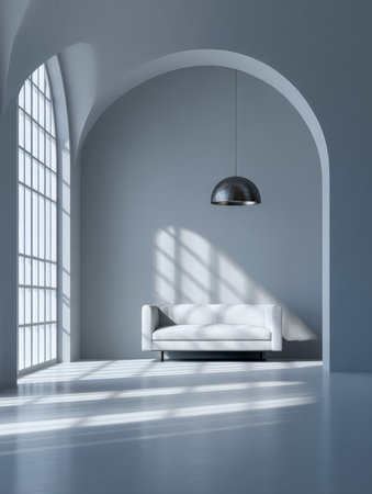A stylish living room features a white sofa positioned under a simple pendant light. Large arched windows allow natural light to cast soft shadows on the gray walls and floor.の素材