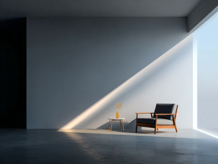 A sleek living room features a contemporary armchair and a small table. Natural light streams through the window, creating a warm atmosphere in the afternoon. The color scheme is simple and calm.の素材