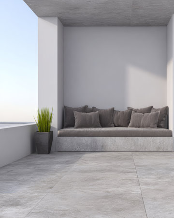 This space features a modern seating area with soft pillows, nestled in a minimalist room that overlooks a serene sea at sunset. The clean lines create a calm atmosphere.の素材