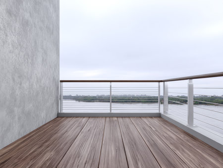 A spacious balcony features wooden flooring and a modern railing. The view includes a calm body of water under a cloudy sky, creating a serene atmosphere for relaxation.の素材