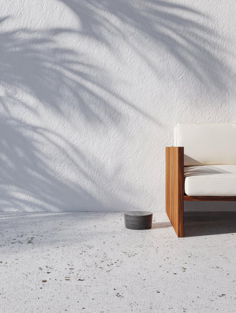 A stylish wooden armchair sits against a white wall, casting intricate shadows from a nearby plant. A minimalistic bowl rests on the textured floor, adding to the serene atmosphere.の素材