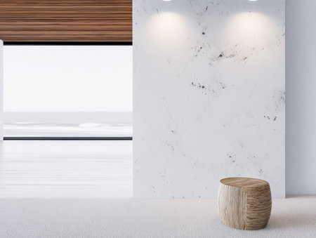 A stylish room showcases a minimalist design with a wooden stool placed against a sleek white wall. Soft lighting enhances the clean and spacious atmosphere, creating a serene environment.の素材