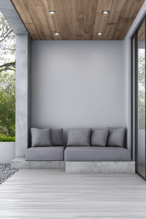 Comfortable gray sofa with cushions is placed on a wooden deck under a sleek wooden ceiling. The area is surrounded by lush greenery, creating a peaceful outdoor retreat.の素材