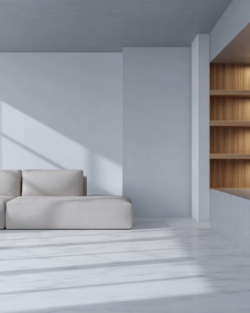A spacious living room features a simple white couch and wooden shelves creating a soothing atmosphere. Sunlight casts soft shadows across the light floor, enhancing the calm feel.の素材