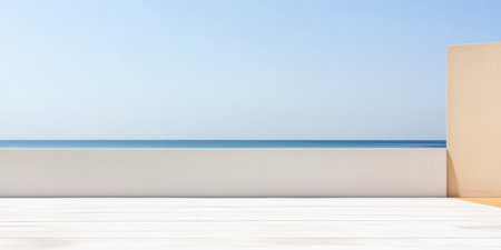 A serene setting by the sea features a vast blue sky and gentle waves lapping against the shoreline. The bright, clean space invites relaxation and tranquility.の素材