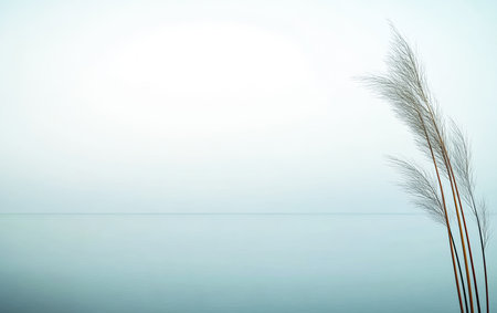 Soft grass stands tall on the shore as the sun rises, casting a gentle glow on the still water. The atmosphere is peaceful and serene, inviting relaxation.の素材