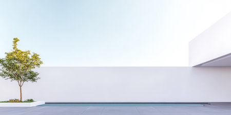 A modern patio showcases a clean, minimalist design featuring a small tree beside a tranquil pool. The bright white walls and clear blue sky create an open and airy atmosphere.の素材