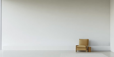 A spacious room features a simple design with a beige chair placed against a white wall. Bright natural light streams in from a large window, creating a calm atmosphere.の素材