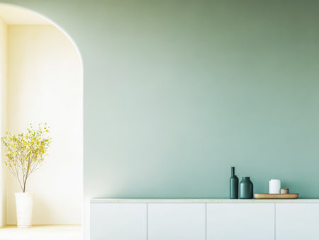 Bright and airy room features a pale green wall, a stylish console with vases and candles, and a potted plant adding a touch of nature. Sunlight streams in through a large archway.の素材