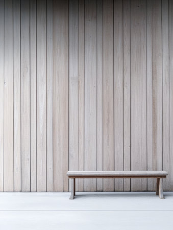 A sleek wooden bench is positioned against a light wooden wall. The minimalist design creates a calm and tranquil atmosphere in the indoor environment, highlighting simplicity.の素材