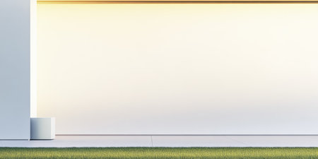 A minimalist building exterior showcases a simple design with smooth white walls illuminated by soft evening light. Fresh green grass contrasts with the clean surfaces, creating a tranquil atmosphere.の素材