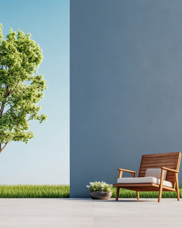 An inviting outdoor area features a comfortable wooden chair, a lush green tree, and a solid blue wall. The scene captures a peaceful atmosphere under a clear sky.の素材
