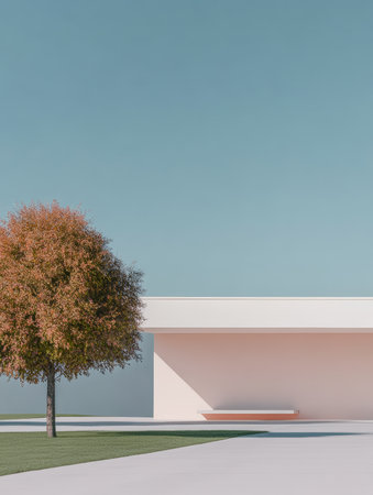 A vibrant tree stands beside a sleek, modern building in a minimalist setting. The clear blue sky provides a serene backdrop, enhancing the calm atmosphere of the space.の素材