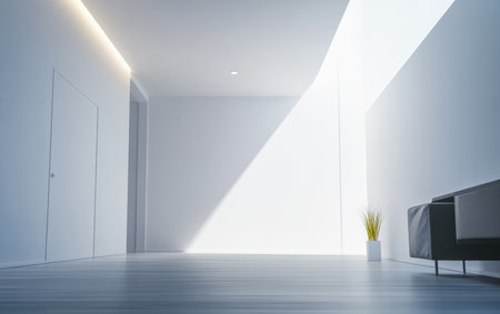 A serene interior features clean lines and ample natural light streaming through a large window. A simple plant in a white pot adds a touch of greenery to the modern space.の素材