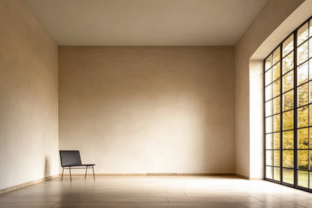 A spacious room features a lone chair against a bare wall. A large window allows natural light to flood in, revealing a glimpse of trees outside, creating a serene atmosphere.の素材