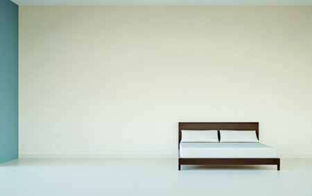 A minimalist bedroom showcases a wooden bed with a plain white mattress. The space features a light color scheme with a subtle blue accent wall, creating a calming atmosphere.の素材