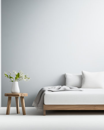 A bright bedroom showcases a white mattress with pillows on a wooden bed frame. A small wooden table holds a vase of fresh flowers, creating a serene atmosphere.の素材