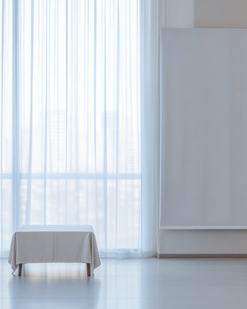 A serene room features a small table draped with a cloth, bathed in natural light from large sheer curtains. The space is minimalist and calming.の素材