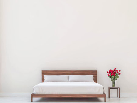 A cozy bedroom features a sleek wooden bed with white bedding. Beside it, a table holds a vibrant bouquet of red roses, enhancing the tranquil atmosphere.の素材