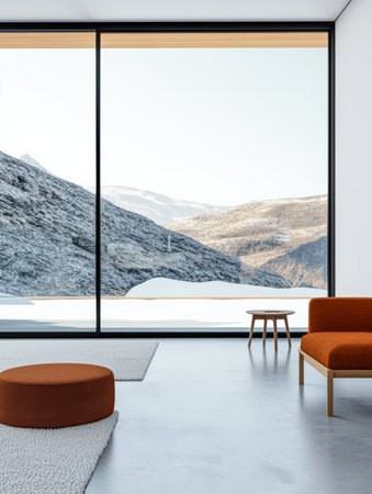A cozy living area showcases minimalist furniture with a round ottoman and a wooden table. Large windows reveal a serene mountainous landscape covered in snow, offering a calm ambiance.の素材