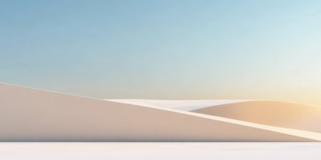 Soft sand dunes stretch across the landscape under a clear blue sky at sunrise, creating a serene and tranquil desert scene. The warm hues of dawn illuminate the gentle curves of the dunes.の素材