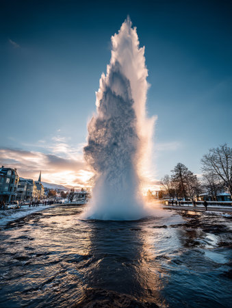 A powerful geyser shoots water high into the air in a snowy setting, illuminated by a vibrant sunset. The scene captures the beauty of nature in winter.の素材
