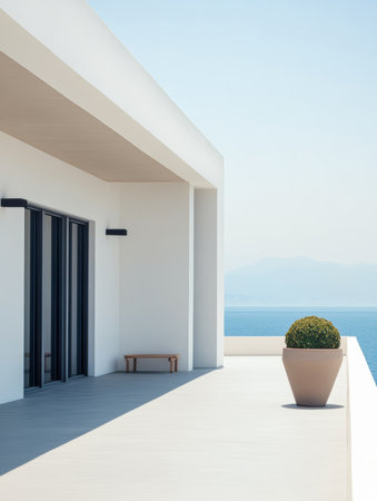 A sleek terrace showcases minimalistic design with clean lines and a beautiful sea view. A potted plant adds a touch of nature under clear blue skies, creating a serene atmosphere.の素材