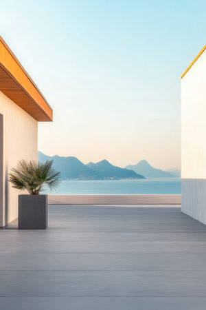 A modern terrace overlooks calm waters, with gentle mountains in the distance during sunset. The scene captures tranquility and stunning natural beauty, perfect for relaxation.の素材