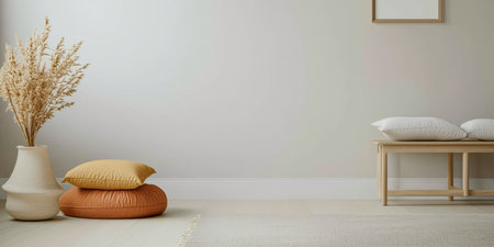 A warm, inviting corner of a living room features a beige wall, stacked cushions on the floor, and a decorative plant in a vase. Sunlight gently brightens the space.の素材