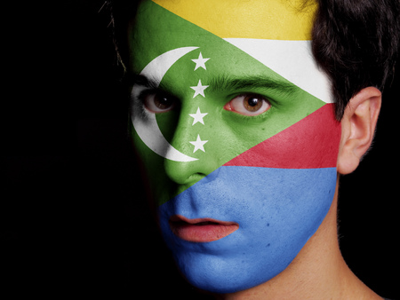 Flag of Comoros Painted on a Face of a Young Man