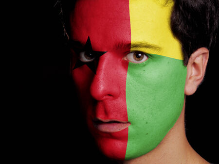 Flag of Guinea-Bissau Painted on a Face of a Young Manの写真素材