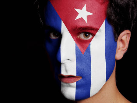 Flag of Cuba Painted on a Face of a Young Manの写真素材