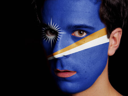 Flag of Marshall Islands Painted on a Face of a Young Manの写真素材