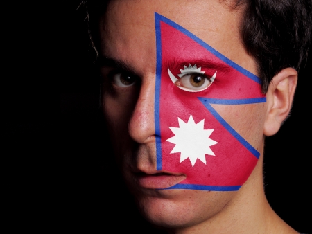 Flag of Nepal Painted on a Face of a Young Manの写真素材