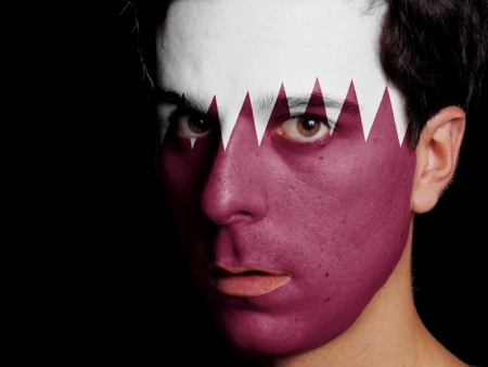 Flag of Qatar Painted on a Face of a Young Man