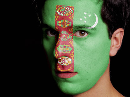 Flag of Turkmenistan Painted on a Face of a Young Manの写真素材