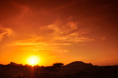 Sunset in Eastern Province. A colourful sky above the peaks of the Hajar Mountains, near Al Ain, UAE, part of the Hajar rangeの写真素材