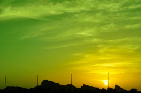 Sunset in Eastern Province, Abu Dhabi. A colourful sky above the peaks of the Hajar Mountains, near Al Ain, UAE, part of the Hajar rangeの写真素材
